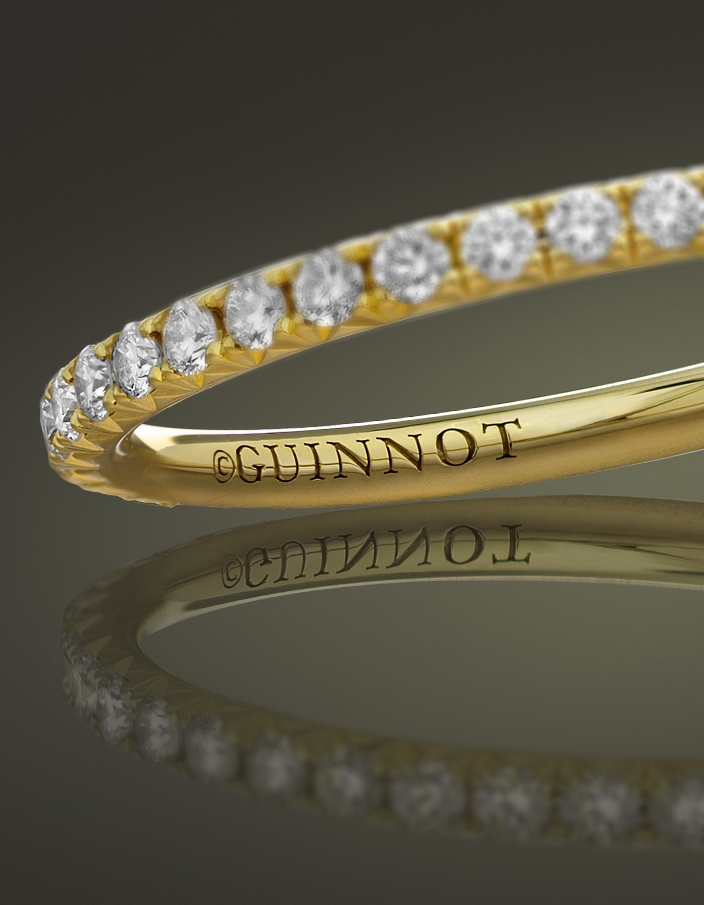 The inside of an yellow golden ring, in which 'Guinnot' is engraved